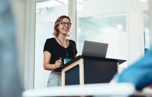 Confident speaker at a podium.