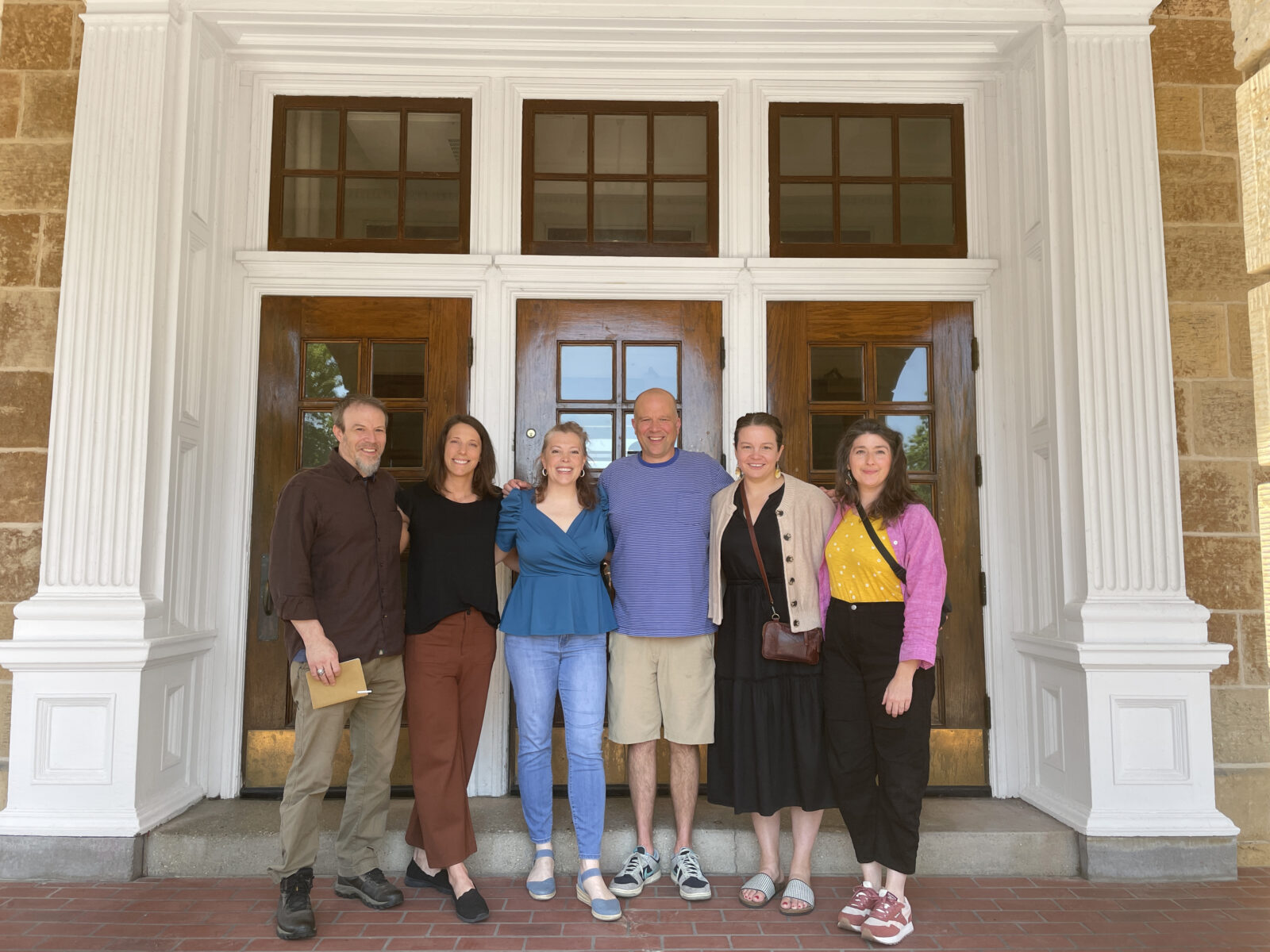Photo of James, Melanie, Kate, Matt, Elizabeth, and Heather standing outside of Bascom hill, and looking very friendly.